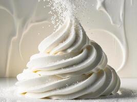 A white whipped cream is being sprinkled on top of a white background photo