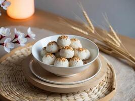 Celebrating lunar new year bowl of rice cakes with sesame seeds festive home setting cultural delight photo