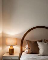 Cozy bedroom with a stylish headboard and warm bedside lamp in a serene setting photo