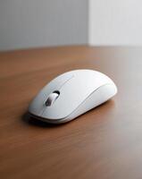 A white computer mouse sitting on top of a wooden table photo