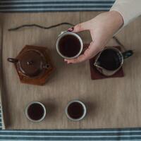 A beautiful and elegant tea ceremony featuring a traditional teapot and matching tea cups photo