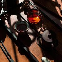 An Elegant Tea Ceremony Setup that Features Natural Light Creating Beautiful Shadows photo