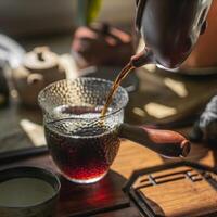 Engaging in the delightful practice of artistic tea brewing with a traditional teapot photo