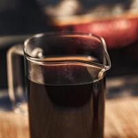 This stylish Glass Pitcher filled with Dark Liquid is Perfect for all Coffee Lovers out there photo