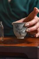 A beautifully Elegant Teacup with an Intricate Design, sitting gracefully in a Calm Setting photo