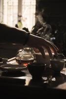 Experience the Serene Art of Tea Preparation Bathed in Soft, Gentle Light and Tranquility photo