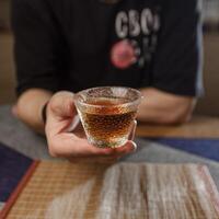 Enjoying a Refreshing Beverage in Hand While Surrounded by a Cozy and Inviting Setting photo