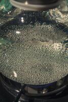 A CloseUp View of Bubbling Water Under a Glass Lid, Capturing the Intricacies of the Scene photo