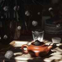 A collection of floating tea leaves gracefully hover above a teapot in a serene setting photo