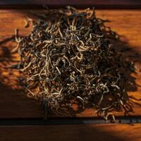 A collection of dried twigs and stems artistically arranged on a rustic wooden surface photo