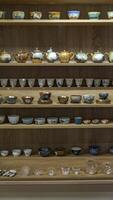 A Beautiful and Elegant Display Featuring Decorative Teapots and Teacups with Flair photo