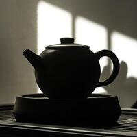 An Artistic and Elegant Silhouette of a Classic Black Teapot Depicting Beautiful Shadows and Light photo