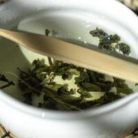 Brewing a delightful Green Tea using Fresh Leaves in a Traditional Pot is an art form photo