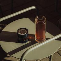Cozy Afternoon Sipping a Warm Cup of Tea and Enjoying the Gentle Glow of a Candle on the Table photo