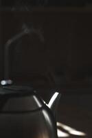 An Elegant Teapot with Steam Rising in Soft Ambient Lighting, Creating a Cozy Atmosphere photo