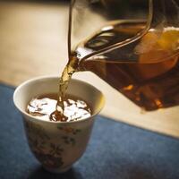 The Art of Tea Pouring into a Delicate and Elegant Cup, Emphasizing the Fine Details photo
