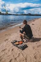 A man relaxes by the riverside, enjoying a peaceful moment and the beautiful view photo
