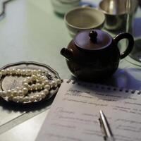 An elegant tea set with exquisite pearls and handwritten notes that enhance its charm photo