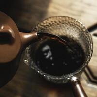 Steaming Brew The Intricate Art of Pouring Tea in a Traditional Teapot for All Occasions photo