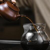 Elegant and refined tea brewing experience with a unique teapot and exquisite glass vessel photo