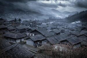 Misty mountain village with traditional houses and overcast sky. photo