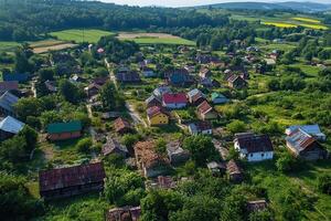 Aerial view of a small village with colorful houses and green fields. photo