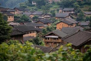 Hillside village with traditional houses and lush greenery. photo