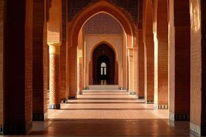 Sunlit corridor with Moorish arches, columns, and terracotta tile floor. photo