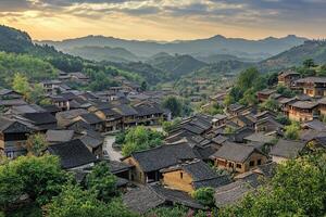 Panoramic view of a traditional village nestled in a mountain valley at sunset. photo