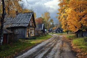 Rustic autumn village road with aged wooden houses and vibrant fall foliage. photo