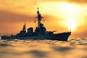 A battleship silhouetted against a sunset at sea. photo
