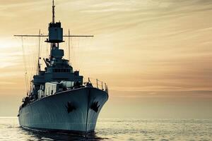 A battleship silhouetted against a sunset at sea. photo