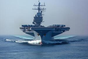 A large aircraft carrier navigating through the ocean. photo