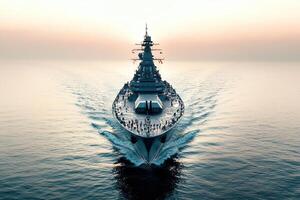 A battleship navigating calm waters at sunset. photo