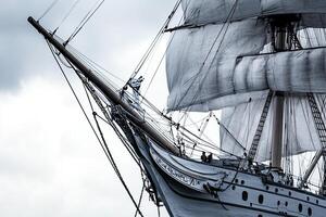 A close-up of a ship's bow with sails unfurled. photo