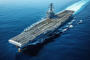 A large aircraft carrier navigating through calm waters. photo