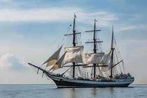 A majestic sailing ship with billowing sails on water. photo