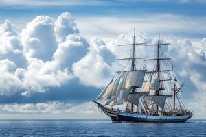 A majestic sailing ship navigating calm waters under clouds. photo
