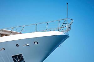 Close-up of a yacht's bow against a clear blue sky. photo