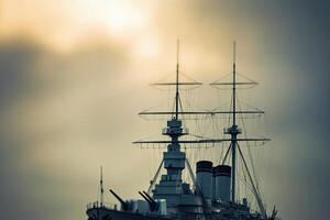 Ship's silhouette against a cloudy sky at sunset. photo