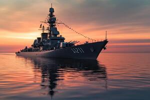 Warship at sunset reflecting on calm waters. photo