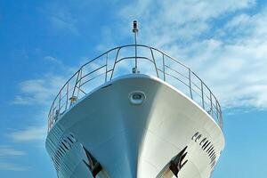 Bow of a yacht against a clear blue sky. photo