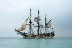 Old sailing ship anchored in calm waters. photo
