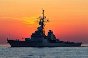 Warship silhouette against a vibrant sunset backdrop. photo