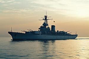 Battleship sailing at sunset on calm waters. photo