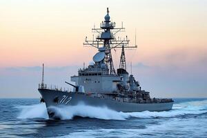 Naval ship navigating through ocean waves at sunset. photo