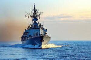 Naval ship navigating through calm waters at sunset. photo