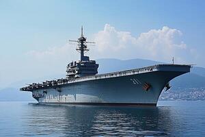 Large aircraft carrier anchored in calm waters. photo
