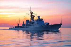 Naval ship sailing at sunset on calm waters. photo