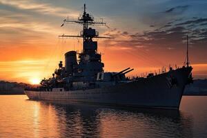 Battleship silhouette against a sunset backdrop. photo